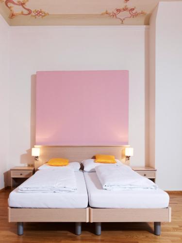 two beds sitting next to each other in a room at CMA Stift Ossiach in Ossiach