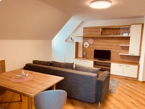 a living room with a couch and a table at Almtalhotel Appartements in Pettenbach in Pettenbach