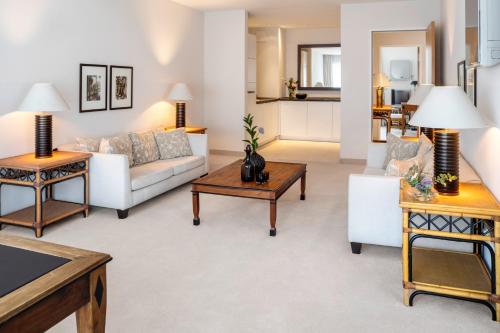 a living room with a couch and a table at The Mandala Suites in Berlin