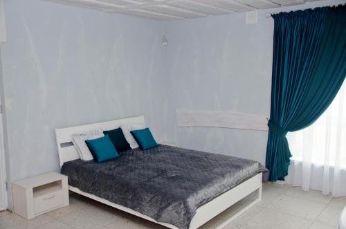 a bedroom with a bed with blue pillows at Apartment Rimkai in Klaipėda