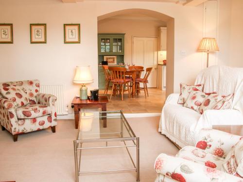 a living room with a couch and a table at The Old Nursery in Much Wenlock