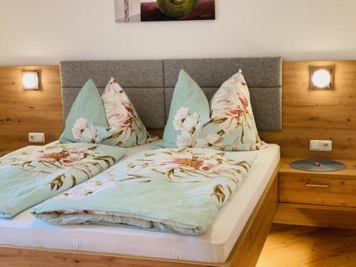 a large bed with pillows on it in a bedroom at Almtalhotel Appartements in Pettenbach in Pettenbach
