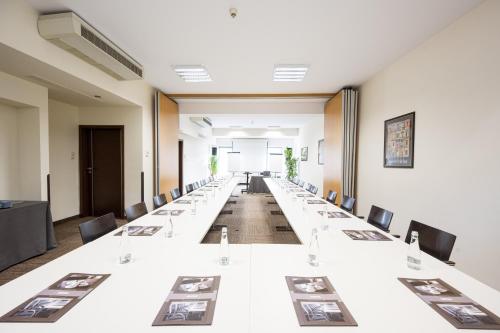 a large conference room with long tables and chairs at Europeum Hotel in Wrocław
