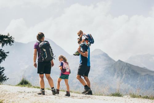 a group of people standing on a dirt road at Isskogel Suites in Gerlos