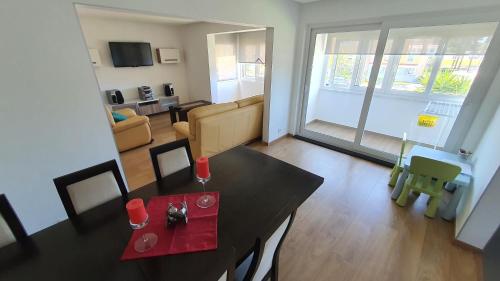 a living room with a table and a living room at A Casa do Parque in Santo André