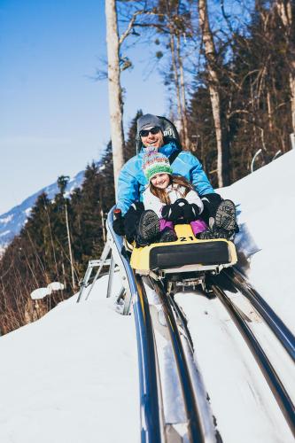 a woman and a child on a ski lift at Isskogel Suites in Gerlos