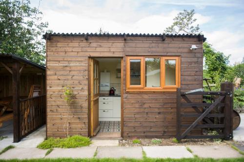 a small wooden shed with a kitchen in it at Withy Cottages in Langport