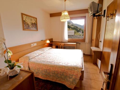 um quarto de hotel com uma cama e uma janela em Hotel Gardenia em Valdidentro