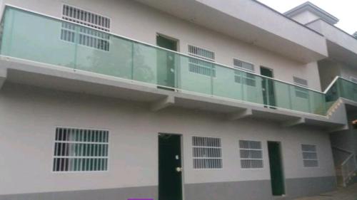 a building with a balcony on the side of it at Apartamento - Anthurium in Joinville