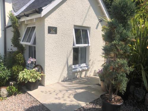 a small house with plants in front of it at Buccleuch Garden Room in Fort William
