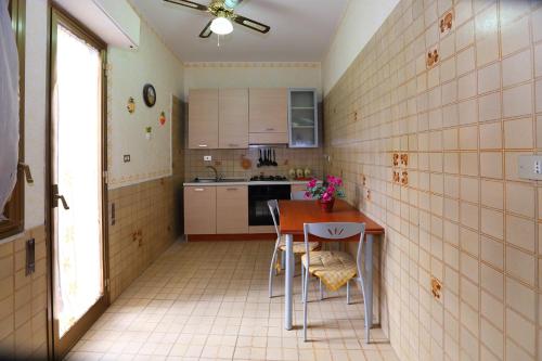 a small kitchen with a table and chairs in it at Antica Dimora Marinelli in Ficarra