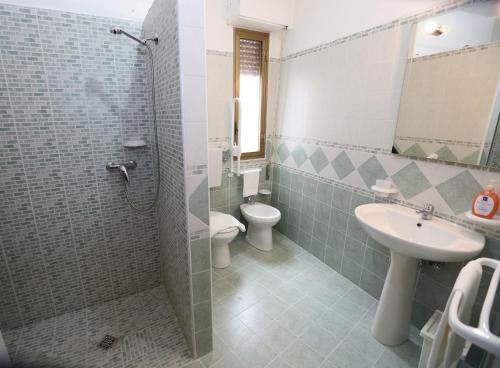 a bathroom with a toilet and a sink and a shower at Antica Dimora Marinelli in Ficarra
