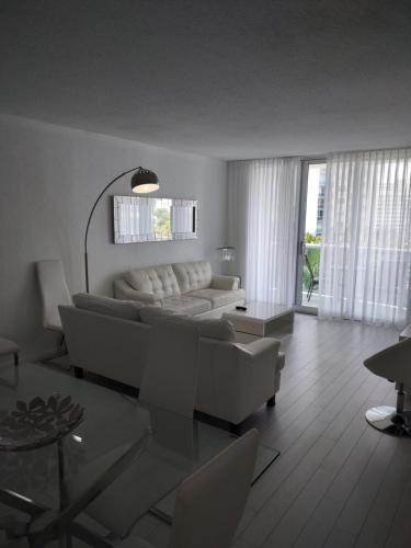 a living room with a couch and a table at Tides Apt on Hollywood Beach in Hollywood