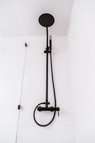 a black fan hanging from the ceiling of a room at we saw athens in Athens
