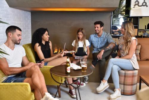 a group of people sitting in a living room at LATROUPE La Granja in Bilbao