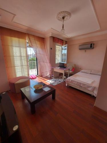 a bedroom with a bed and a table in it at Orhan Villası in Fethiye