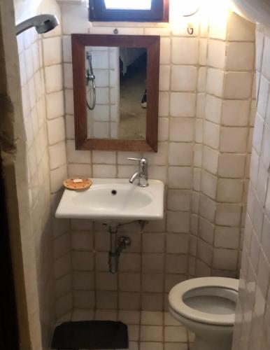 a bathroom with a sink and a toilet at Casa Federico in Ostuni