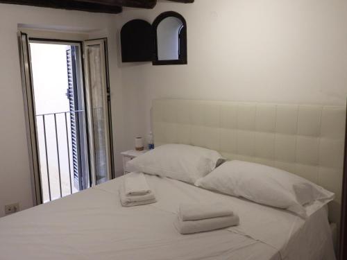 - un lit blanc avec 2 serviettes dans l'établissement Best Apartment in Rome Campo de Fiori, à Rome
