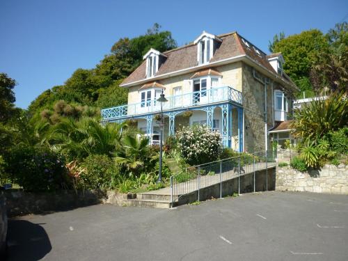 a large house with a porch on a hill at St Maur in Ventnor