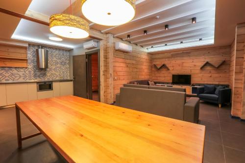 a dining room with a wooden table and chairs at Трипільське Сонце in Podgortsy