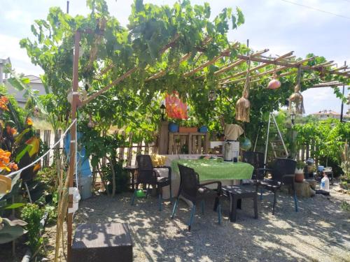 a garden with a table and chairs under a tree at Gulseven Bungalow Villas in Dalaman