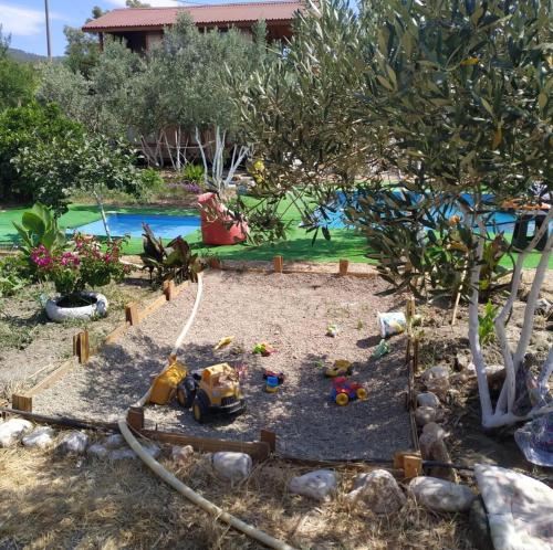 a garden with a toy train in a yard at Gulseven Bungalow Villas in Dalaman