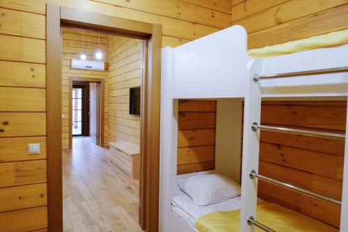a bedroom with bunk beds in a cabin at Трипільське Сонце in Podgortsy