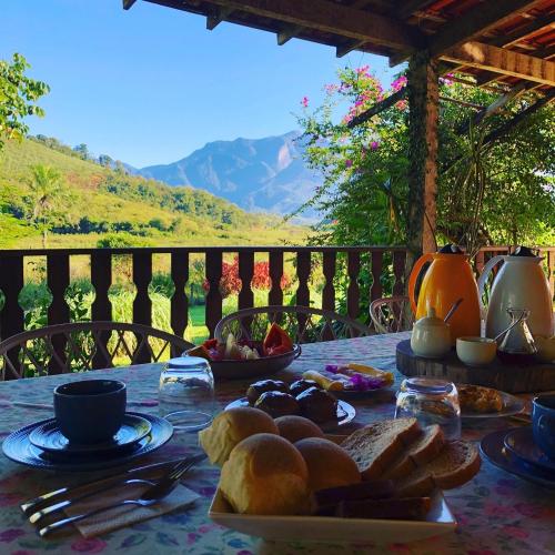 a table with a plate of food on top at Guest House Fazenda do Francês & Culinária Francesa in Cachoeiras de Macacu