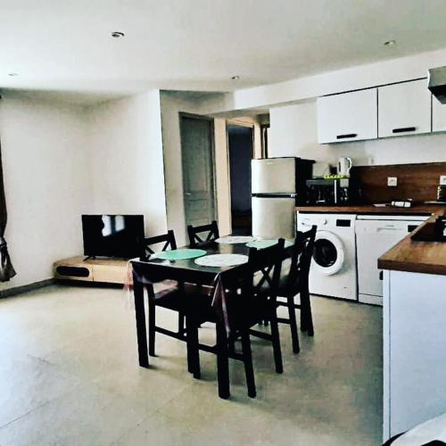 a kitchen with a table and chairs in a room at Gite Libecciu in Pietracorbara