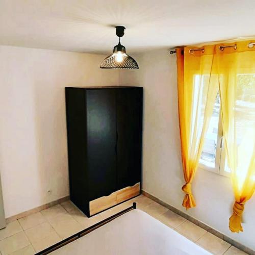 a living room with a large black screen and windows at Gite Libecciu in Pietracorbara