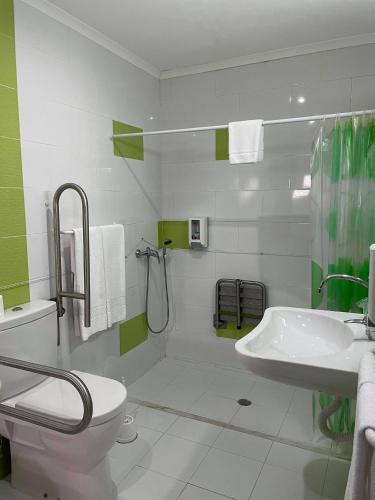 a bathroom with a toilet and a sink and a shower at Hotel Rural A Coutada - Peniche in Atouguia da Baleia