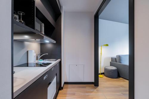 a kitchen with a sink and a counter at Nena Apartments - Kreuzberg 61 in Berlin