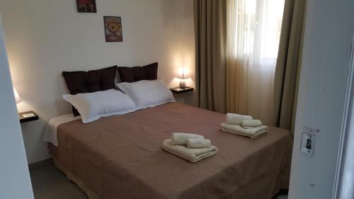 a bedroom with a bed with towels on it at γαληνη in Vamos