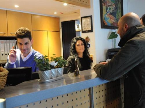 
a woman and a man are looking at a laptop at Hotel Ulmer Stuben in Ulm
