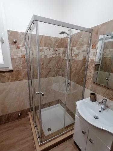 a shower with a glass door next to a sink at Tenuta San Lorenzo in Otranto
