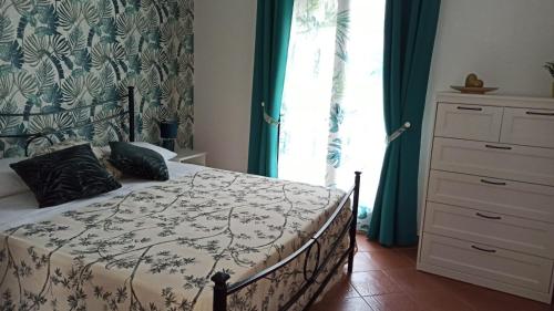 a bedroom with a bed and a window at Original Sicily in Santa Venerina