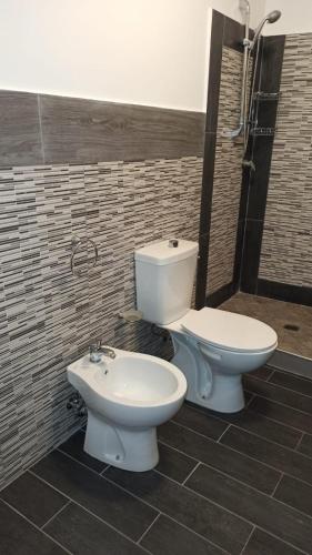 a bathroom with a toilet and a bidet at Original Sicily in Santa Venerina