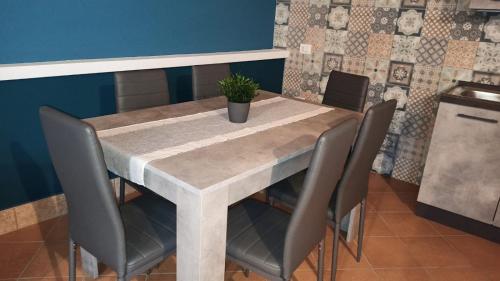 a dining room table with a potted plant on it at Original Sicily in Santa Venerina