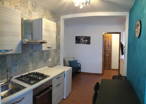 a kitchen with a sink and a stove top oven at Original Sicily in Santa Venerina