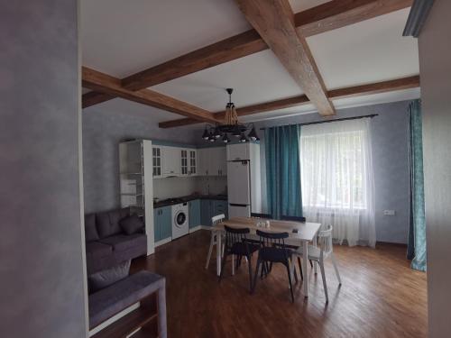 a kitchen and dining room with a table and chairs at Abbasov's guest house-In Lahij in Lahıc
