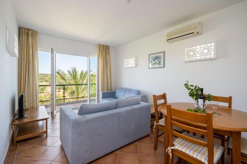 a living room with a couch and a table at Quinta do Morgado - Apartamentos Turisticos Monte Da Eira in Tavira