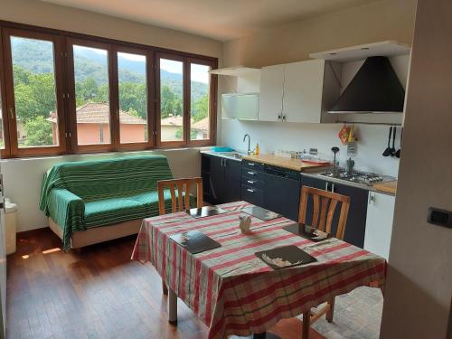 a kitchen with a table and a kitchen with a bed at Locanda del Brinsc in Brinzio