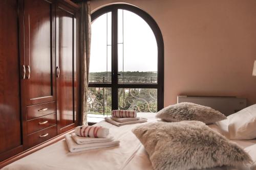 a bedroom with a bed with a large window at Apartments Leonarda in Portorož