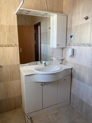 a bathroom with a white sink and a mirror at Empera H-l in Sunny Beach