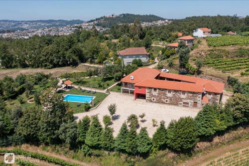 an aerial view of a house with a swimming pool at Quinta da Urtigueira in Felgueiras