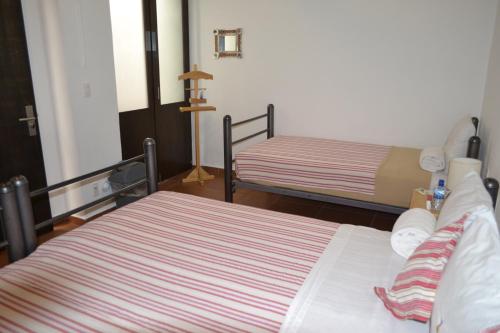 a room with two beds in a room at Mexico City Hostel in Mexico City