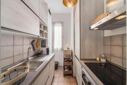 a kitchen with a sink and a counter top at Casa Royale Appartamento Terra in Lierna