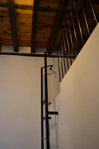 a staircase with a light on the side of a white wall at Mexico City Hostel in Mexico City