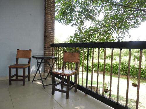 two chairs and a table on a balcony at Villa Juana Hotel in Pereira
