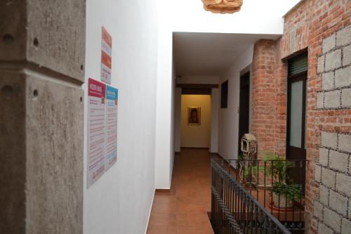 a hallway of a building with a sign on the wall at Mexico City Hostel in Mexico City